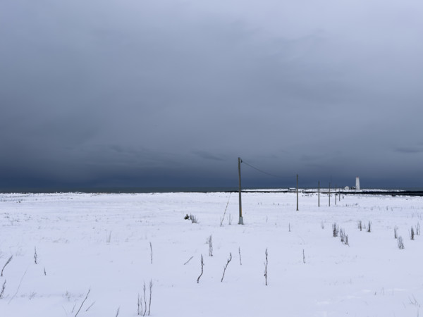 Snowy field with dramatic gray sky