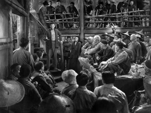 Turhan Bey (standing on steps), Katharine Hepburn (standing right of Bey), on-set of the film,