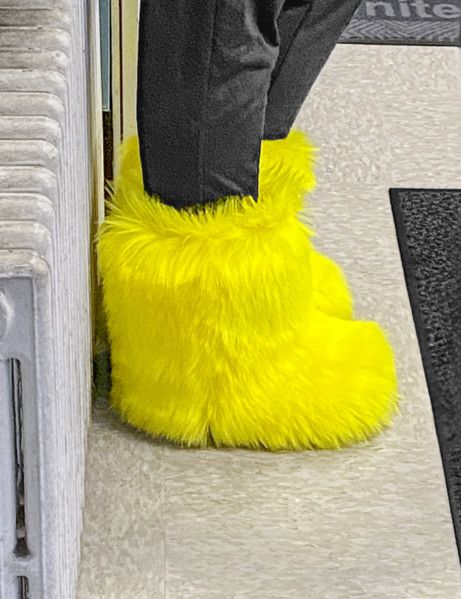 Woman wearing bright yellow furry boots