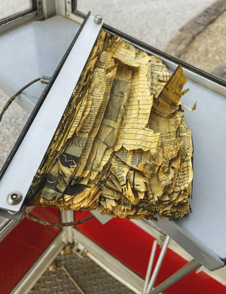 Tattered and torn phone book inside old telephone booth