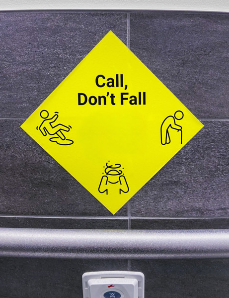 Yellow call for help sign in hospital bathroom