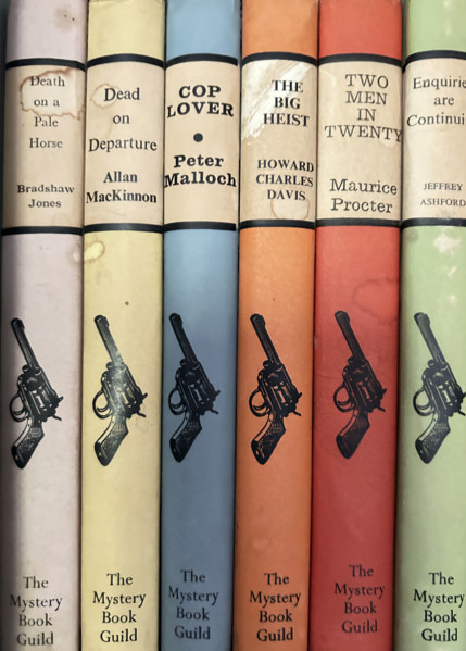 Row of mystery and crime novels on bookshelf