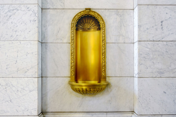 Gilded niche recessed in marble wall