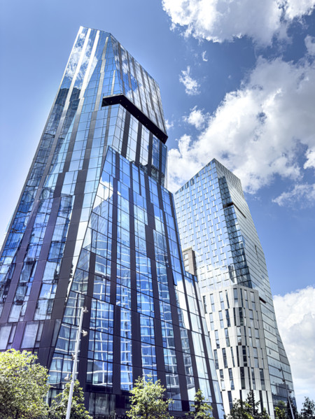Three Waterline Square (left), a mixed-use residential building, and One Waterline Square (right),