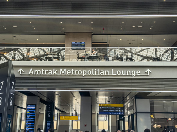 Direction sign for Amtrak Metropolitan Lounge, Moynihan Train Hall, Pennsylvania Station,