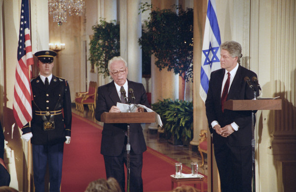 U.S. President Bill Clinton looking on as Israeli Prime Minister Yitzhak Rabin delivers press