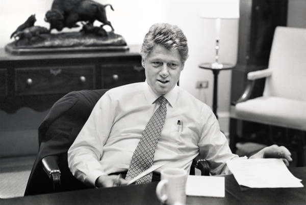 U.S. President Bill Clinton sitting at  conference table during meeting in the White House,
