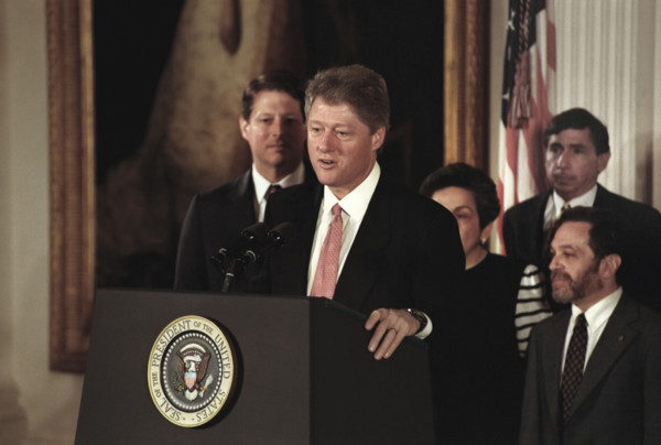 U.S. President Bill Clinton standing at podium after swearing-in the first members of his cabinet