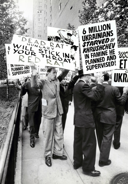 Group of people with signs protesting Soviet Leader Nikita Khrushchev's visit to United Nations,