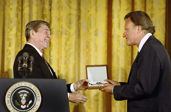 U.S. President Ronald Reagan presenting American evangelist Billy Graham in the East Room of the