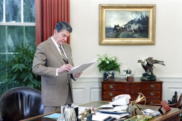 U.S. President Ronald Reagan working at his desk, White House Oval Office, Washington, D.C., USA,