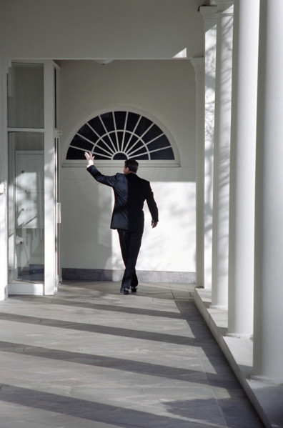U.S. President Ronald Reagan waving goodbye as he walks along White House Colonnade for the last