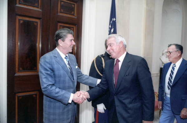 U.S. President Ronald Reagan shaking hands with retired American baseball player Joe DiMaggio at