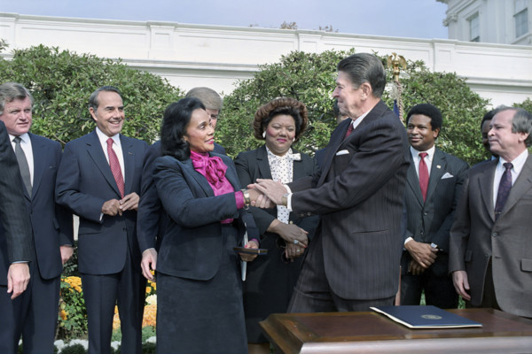 U.S. President Ronald Reagan shaking hands with Coretta Scott King at signing ceremony for HR 3706
