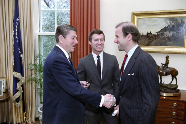 U.S. President Ronald Reagan meeting with U.S. senators Joseph Biden and William Cohen to discuss