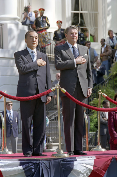 U.S. President Ronald Reagan and Prime Minister Yasuhiro Nakasone  of Japan listening to national