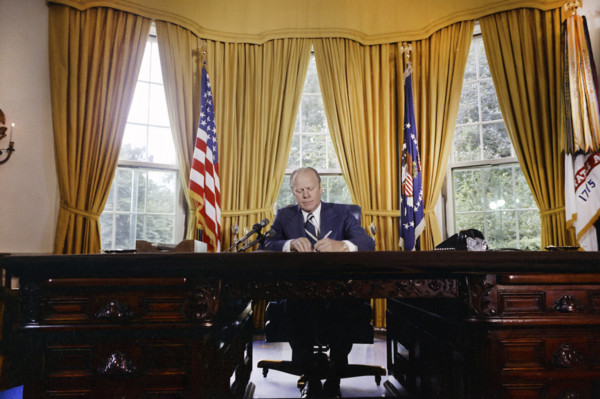 U.S. President Gerald R. Ford signing proclamation granting pardon to former U.S. President Richard