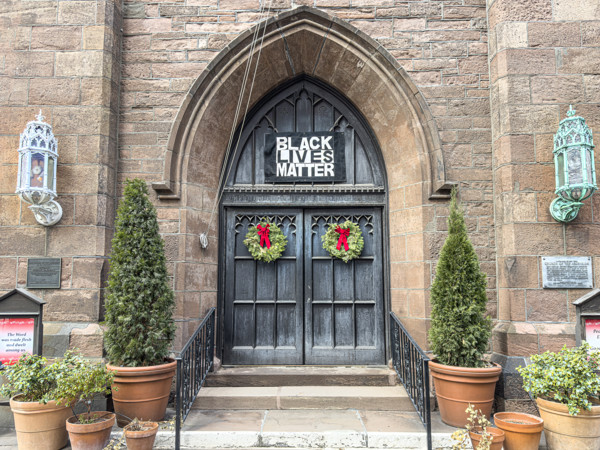 Black Lives Matter sign hanging above entrance to Church of the Ascension, Episcopal church,