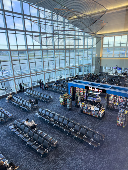 High angle view of travelers relaxing in departure lounge, Delta Airlines, Fort