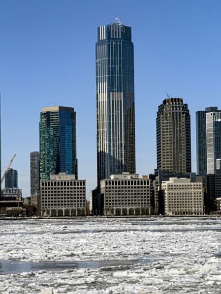 View of Jersey City, New Jersey, USA skyline with 99 Hudson Street (center) across frozen Hudson