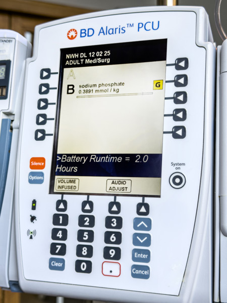 Close-up detail of BD Alaris PCU IV pump machine in hospital room