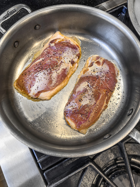 High angle view of sauteed duck breast in pan