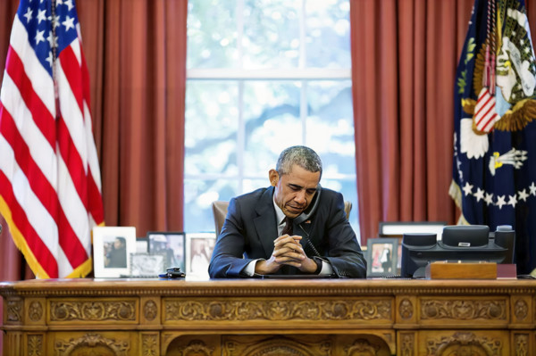 U.S. President Barack Obama talking on telephone with pastors who offer birthday prayer during call