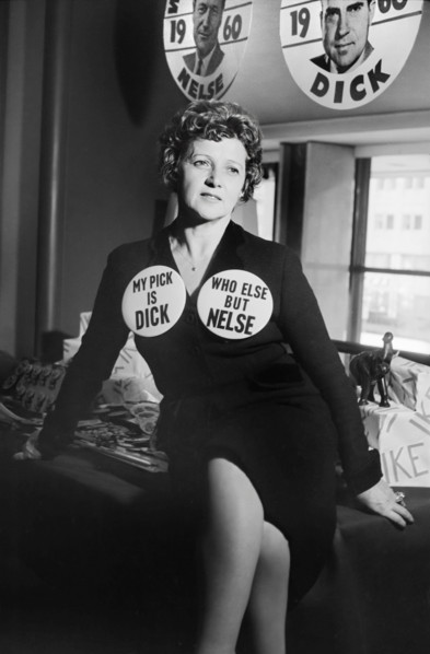 Woman seated on table, wearing Republican Party buttons supporting Richard Nixon and Nelson