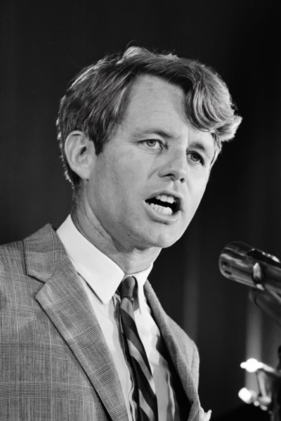 New York Senator Robert F. Kennedy of New York, speaking at a microphone at a United States Chamber