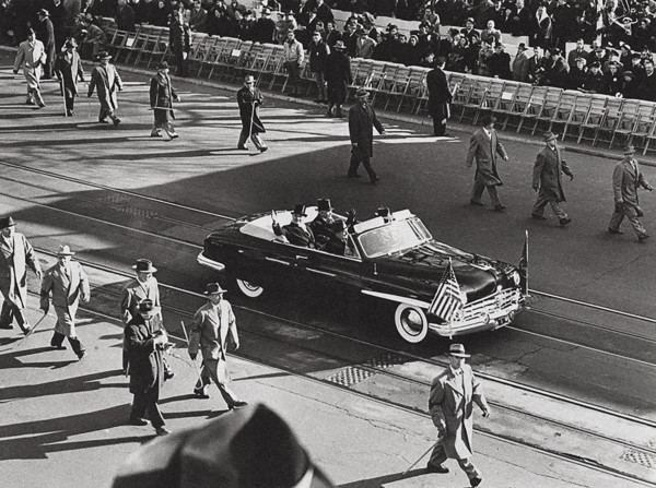 U.S. President Harry S. Truman and U.S. Vice President Alben Barkley wave to crowds their car