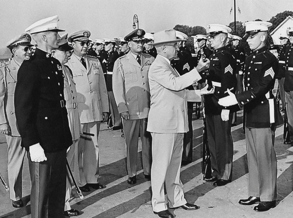 U.S. President Harry S. Truman inspecting rifle of unidentified Marine during visit to U. S. Marine