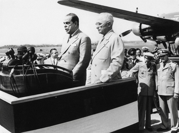 U.S. President Harry S. Truman (center-right) standing beside Romulo Gallegos (center-left),