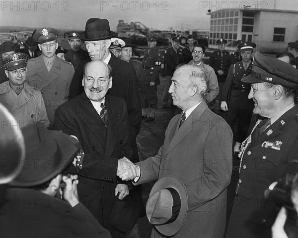 British Prime Minister Clement Attlee (foreground, third from right) shaking hands with U.S.