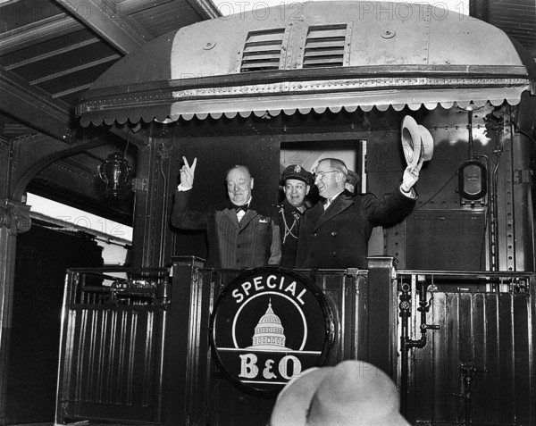 U.S. President Harry S. Truman (right) waving his hat standing to right of former British Prime
