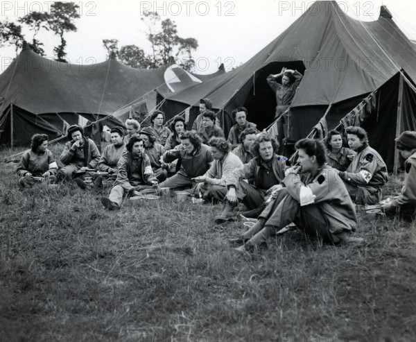 Group of U.S. Army nurses, first to land with the vanguard of American troops, eating dinner at