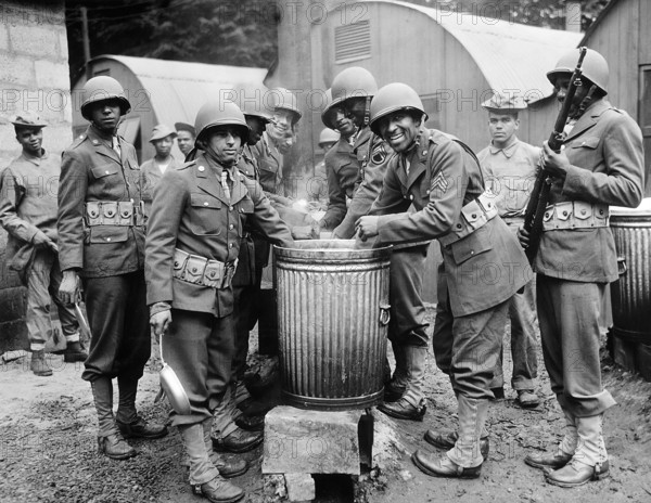 African American soldiers drawing rations at camp cook house, Northern Ireland, U.S. Office of War