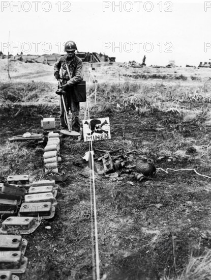 1st Lieutenant Merle Kirstein, Des Moines, Iowa, going through German-marked minefield with