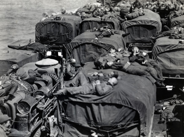 American assault troops aboard landing craft enroute from England to Cherbourg, France, U.S. Army