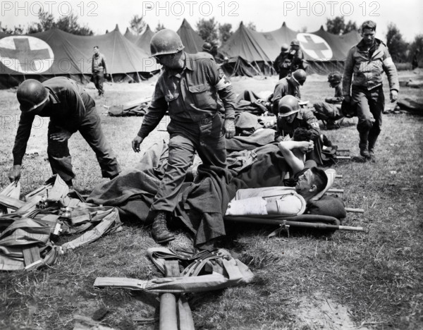 U.S. Army medics making their patients comfortable and begin to distribute life belts to them at a