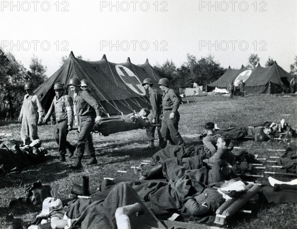 American Medics of 8th Infantry Regiment, 4th Infantry Division, bringing American and British