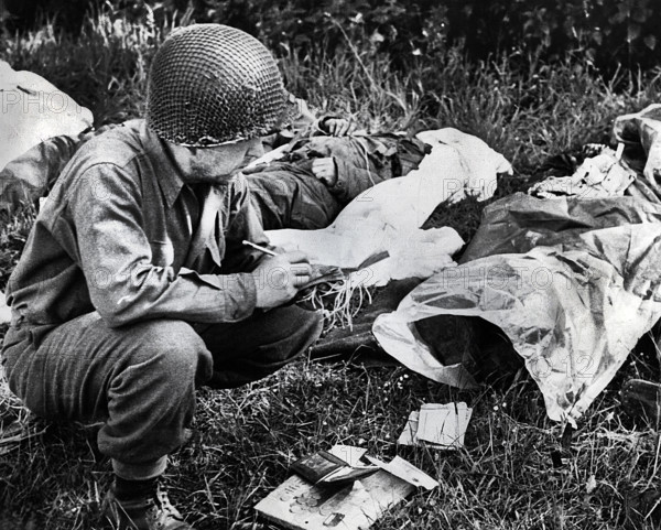 U.S. Sergeant Peter F. Slusarezyk, attached to the Medical Department, tagging a dead American