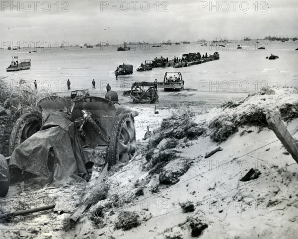 Vehicles of 1st Army Corps being unloaded onto Utah Beach from barge, La Madeleine, Normandy,
