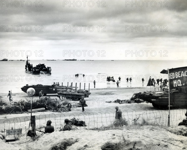 Amphibious trucks bringing in supplies and returning with causalities to the ships for evacuation