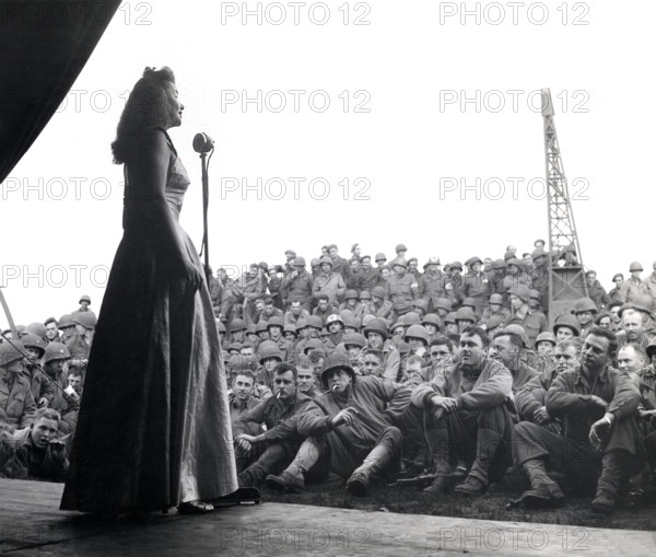 USO singer entertaining American troops of 7th Armored Division, Geldrop, Netherlands, U.S. Army