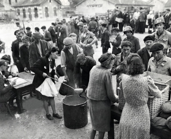 Homeless people who were being cared for by members of civil affairs unit queue up for noonday meal