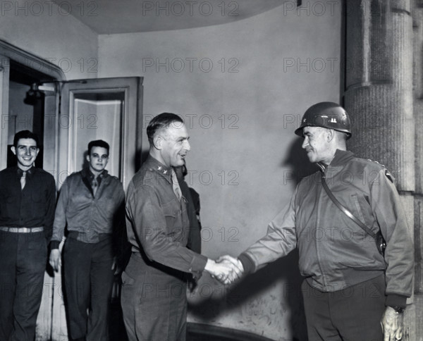 U.S. Lieutenant General Omar N. Bradley (right), 12th Army Group, shaking hands with U.S. Major