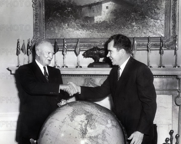 U.S. Vice President Richard M. Nixon shaking hands  while meeting with U.S. President Dwight D.