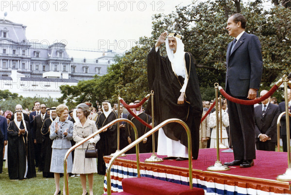 U.S. President Richard Nixon and King Faisal of Saudi Arabia standing on dais with U.S. First Lady