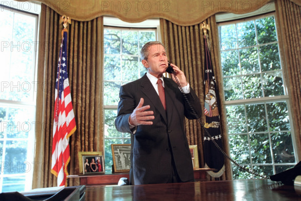 U.S. President George W. Bush talking on telephone with New York Governor George Pataki and New