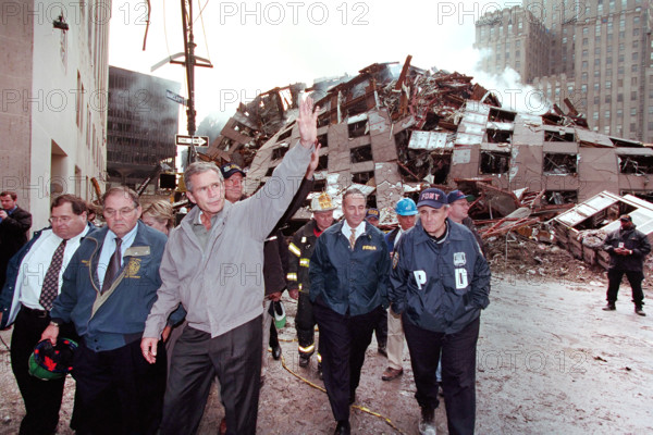 U.S. President George W. Bush waving while touring 7 World Trade Center disaster site with (from